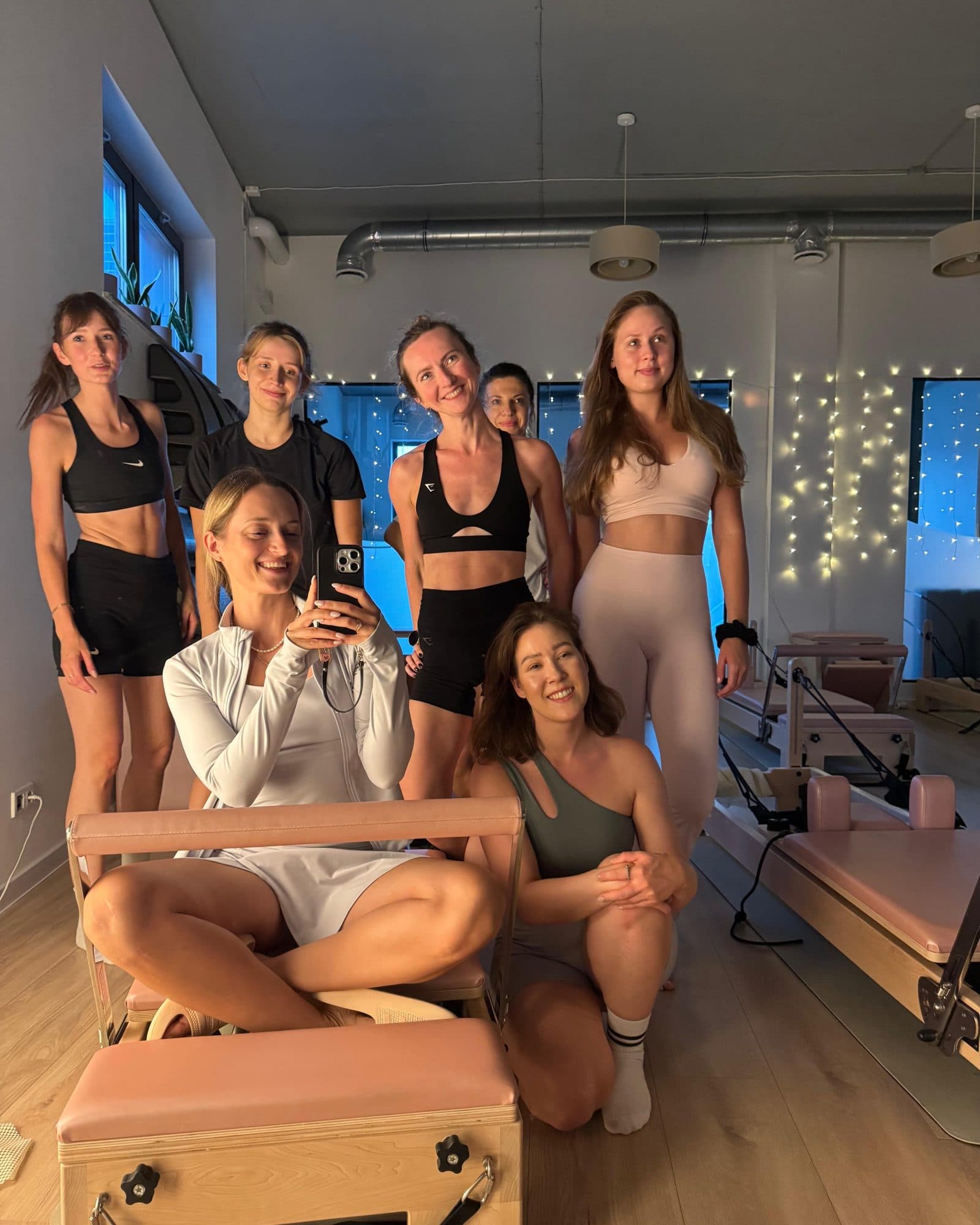 The Zen Pilates team and members together by a reformer in Ząbki